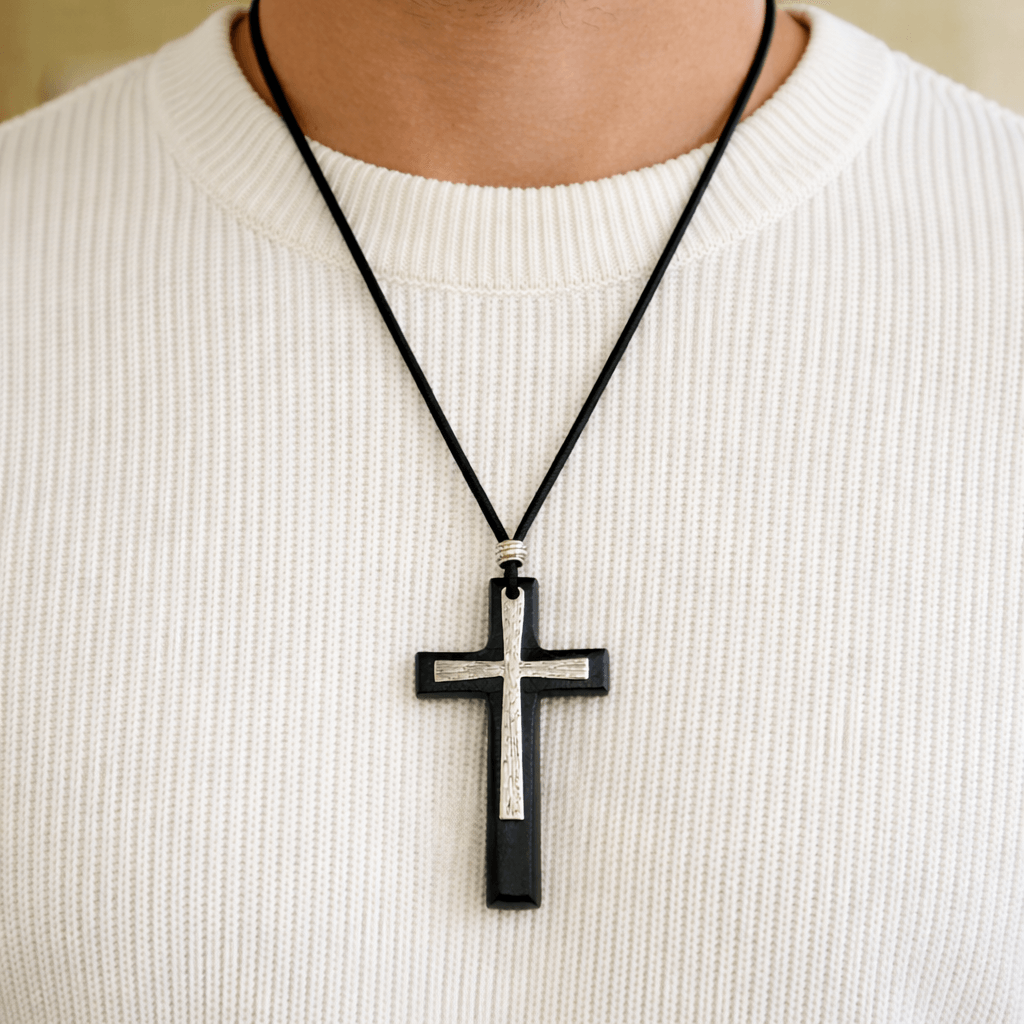 Man wearing black wood cross necklace with leather cord