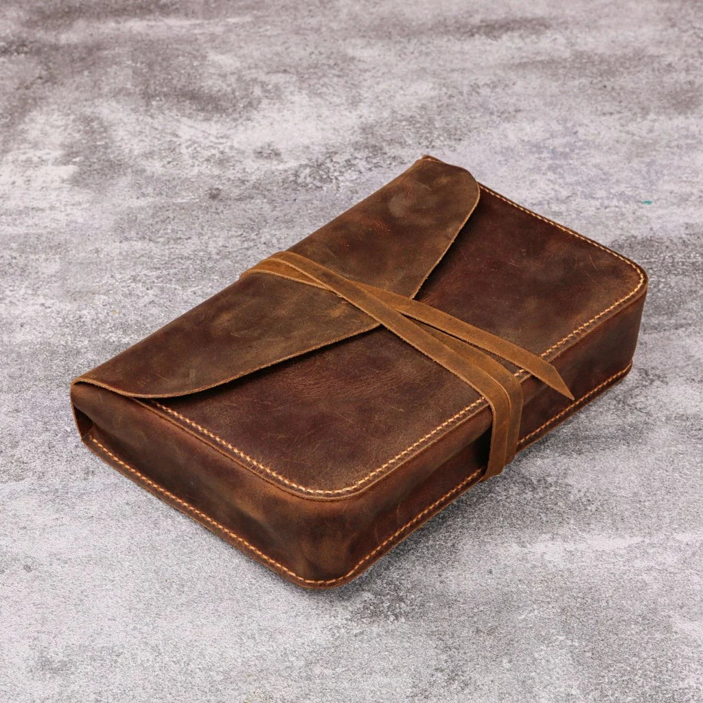 Rustic full-grain leather Bible cover, completely closed and secured with a wrap-around leather strap