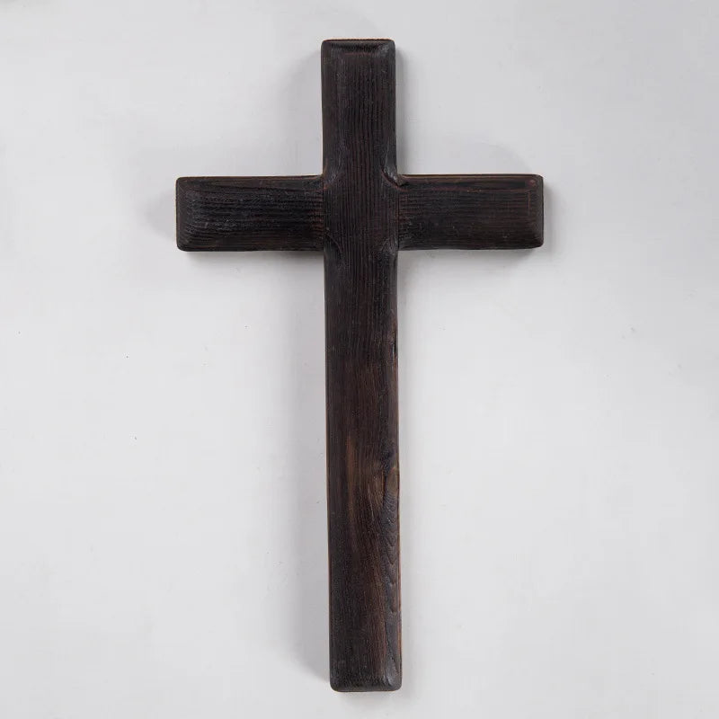 A dark wooden cross shown in a straight-on product view, highlighting its simple silhouette and wood grain against a white background