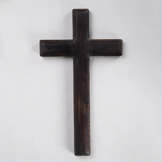 A dark wooden cross shown in a straight-on product view, highlighting its simple silhouette and wood grain against a white background