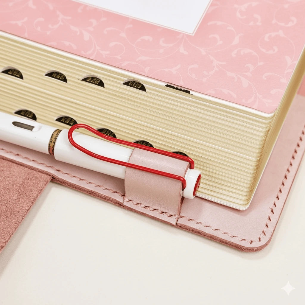 Detailed view of pink Bible cover edges and stitching — soft leather texture and zipper binding.