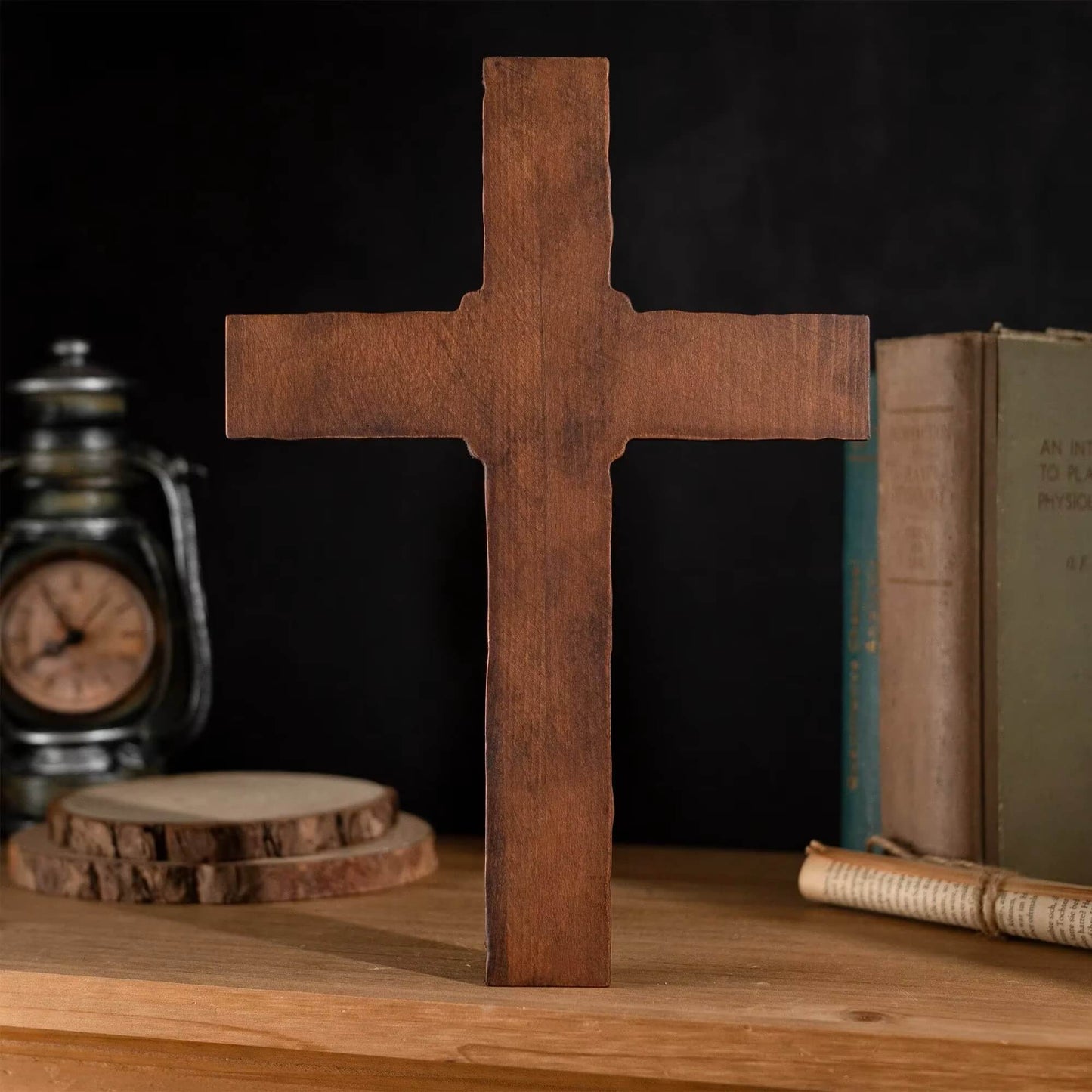Back of Handcrafted wooden cross with a rope detail, displayed on a wooden surface against a dark background