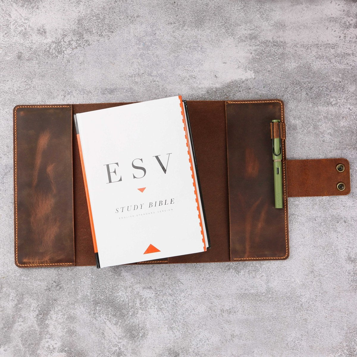 Vintage leather ESV Bible cover with handle, angled view
