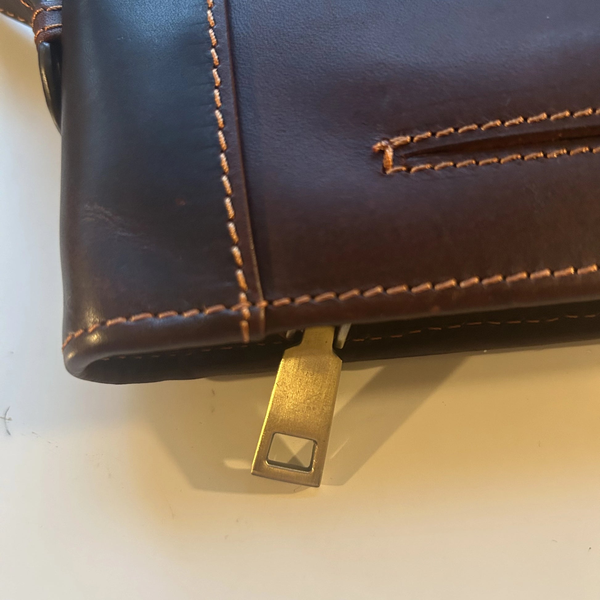 Corner and handle detail of the genuine leather Bible cover with elegant stitching and smooth finish.