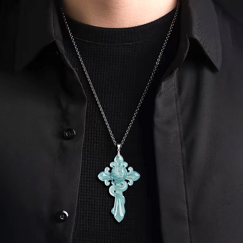 Person wearing a black shirt with a jadeite jade cross pendant necklace.