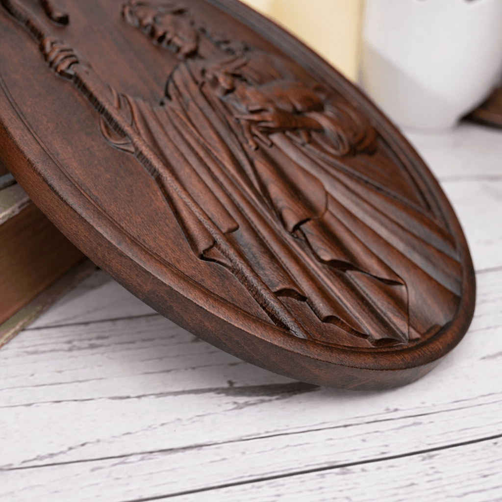 Close-up detail of the thickness and carved edge of a solid wood Jesus relief