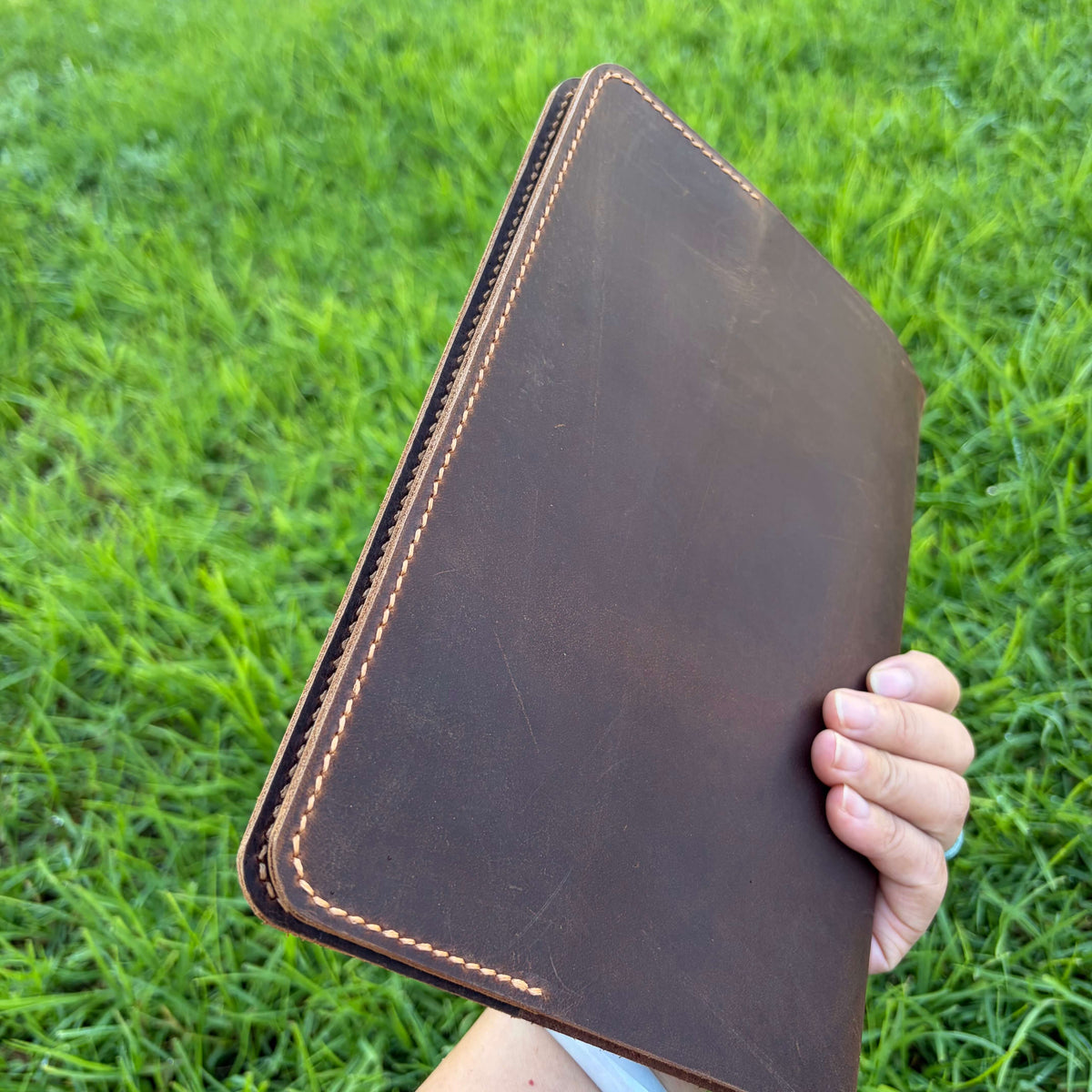 Personalized leather Bible cover held by hand