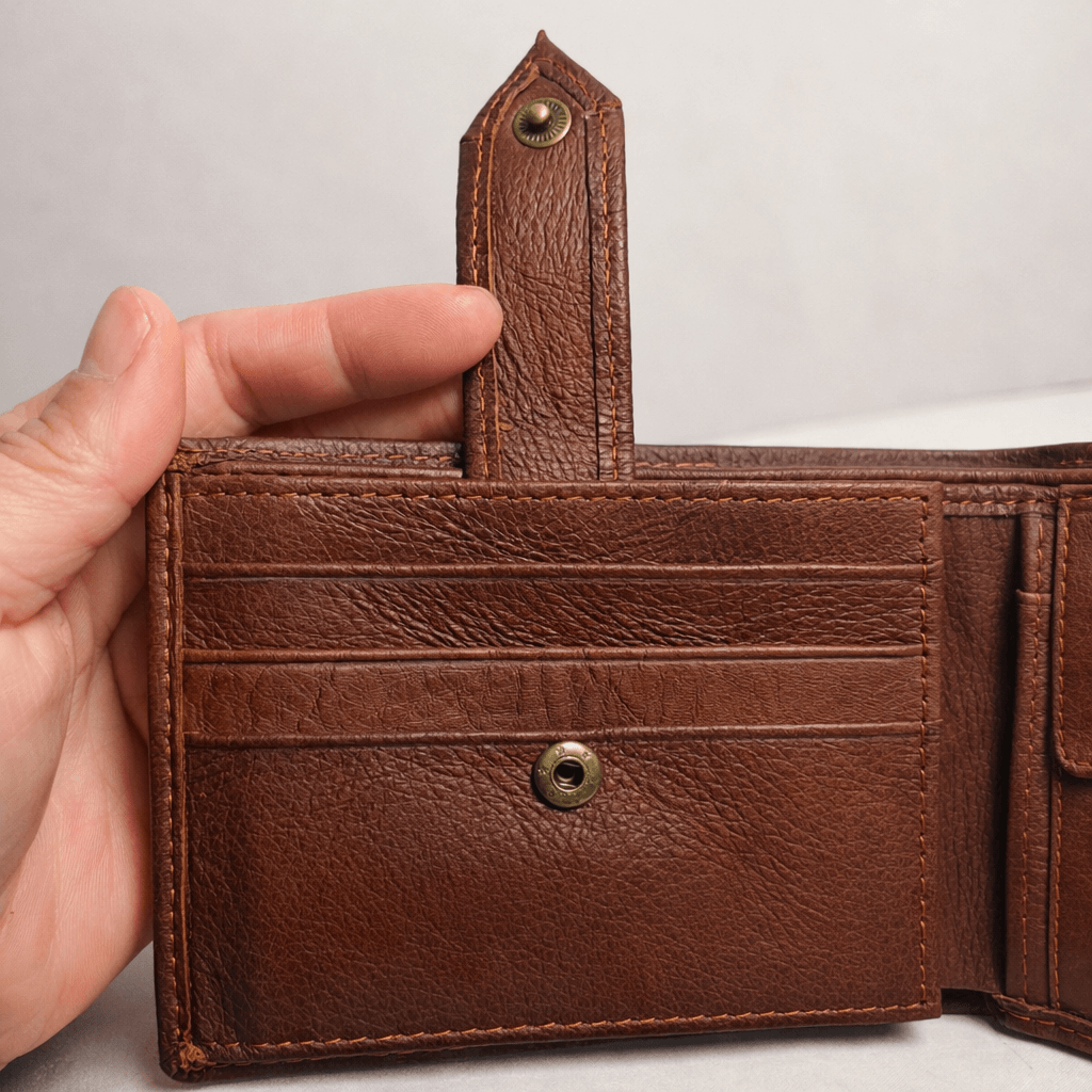 Brown genuine leather wallet interior showing multiple card slots and snap button pocket