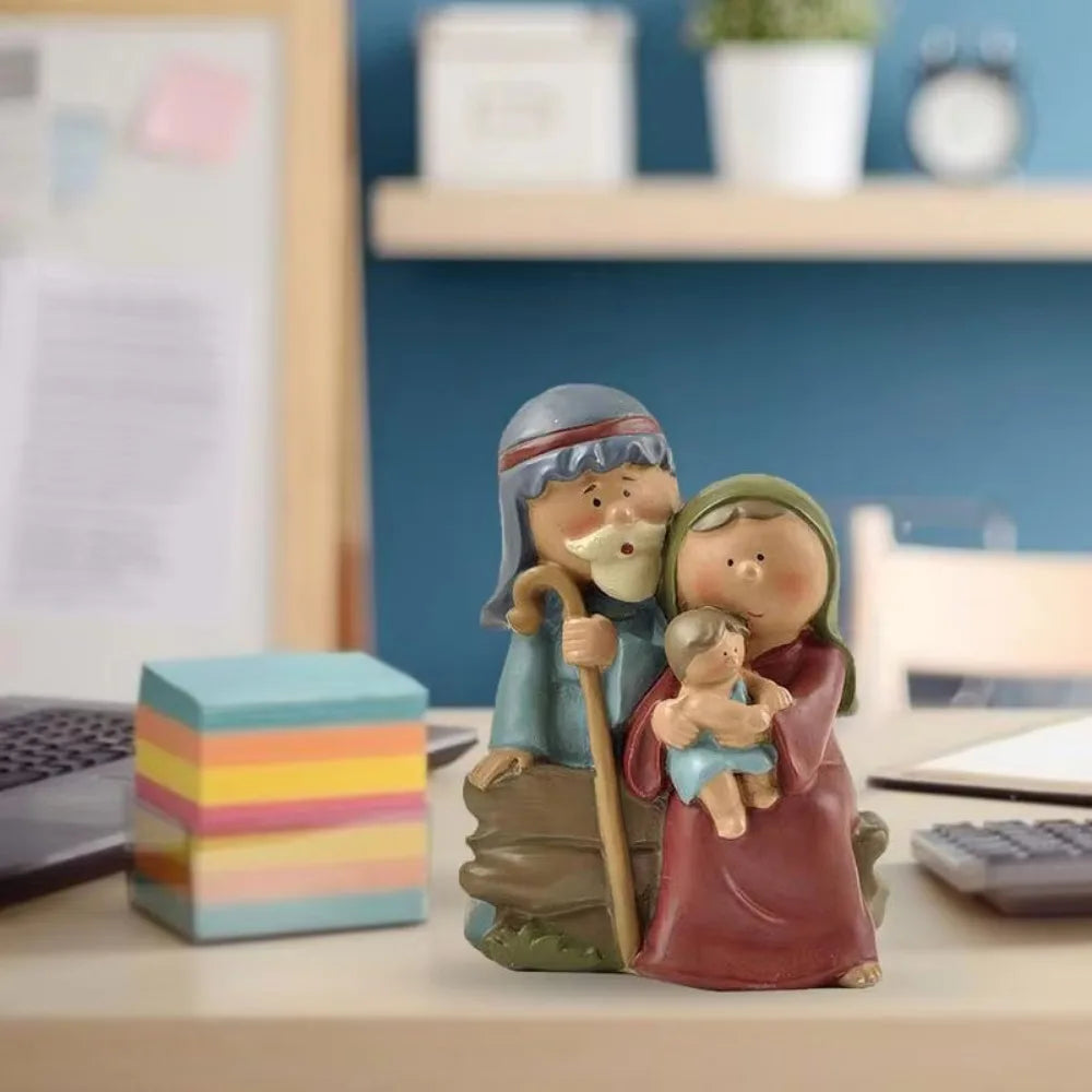 Holy Family Nativity figurine placed on a desk, showing Mary, Joseph, and Baby Jesus in a cute resin design.