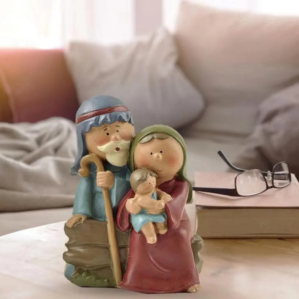 Holy Family Nativity figurine displayed on a table in a cozy living room, featuring Mary, Joseph, and Baby Jesus in a cute resin design.
