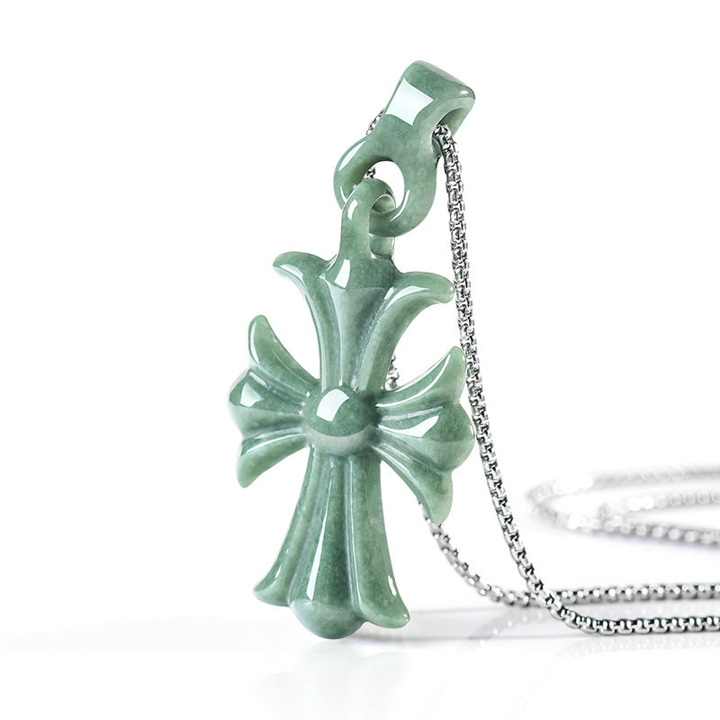 Natural Grade A bean green jadeite cross pendant with silver-toned chain, shown from a side angle on a white background