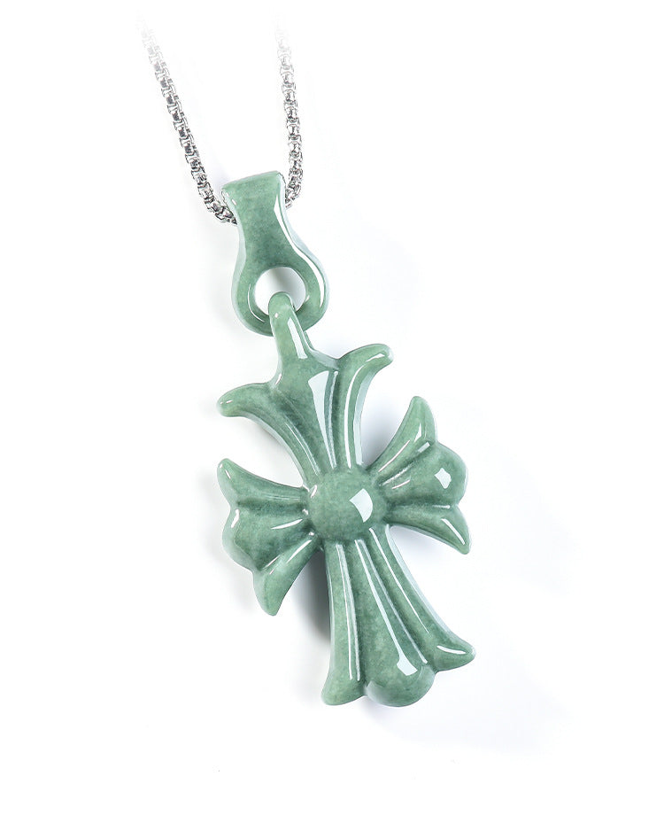 Natural Grade A bean green jadeite cross pendant with a silver chain on a white background