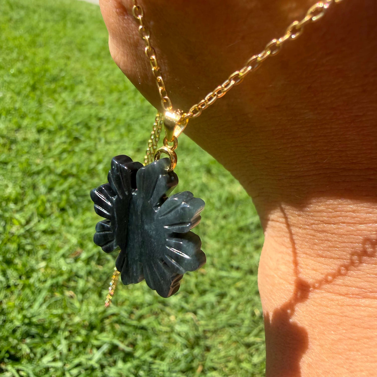 Natural untreated Wuji jadeite Filipino Sunflower pendant with gold-tone chain photographed in natural light