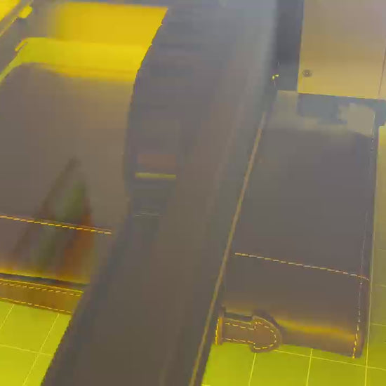 Laser engraving process of a genuine leather Bible cover at Light of Christ Shop – custom name and verse personalization in progress.