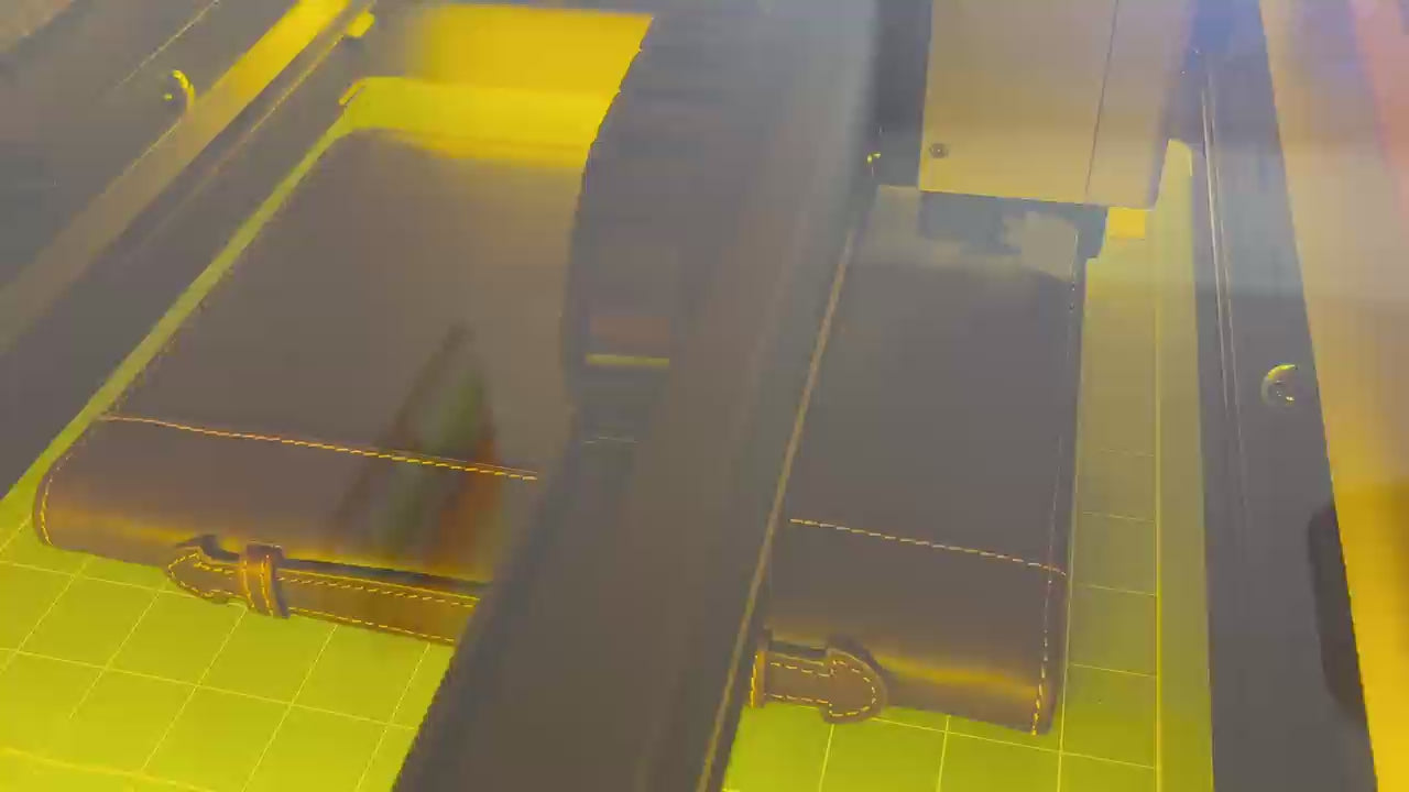 Laser engraving process of a genuine leather Bible cover at Light of Christ Shop – custom name and verse personalization in progress.