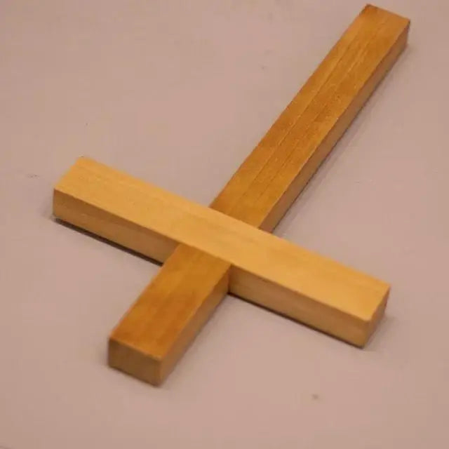 Solid cherry wood cross with a natural finish displayed on a neutral background