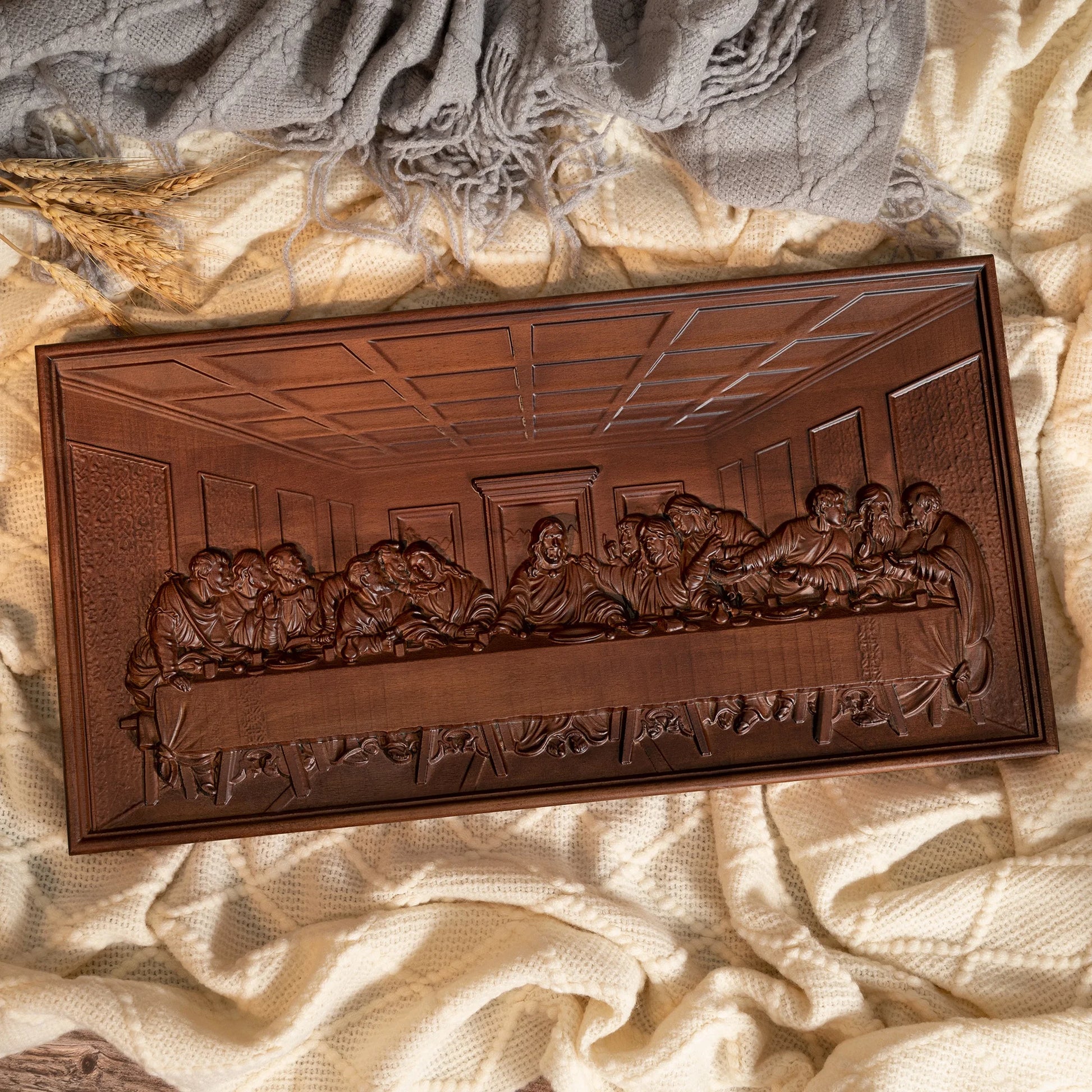 The Last Supper carved beech wood wall plaque displayed on a textured fabric background
