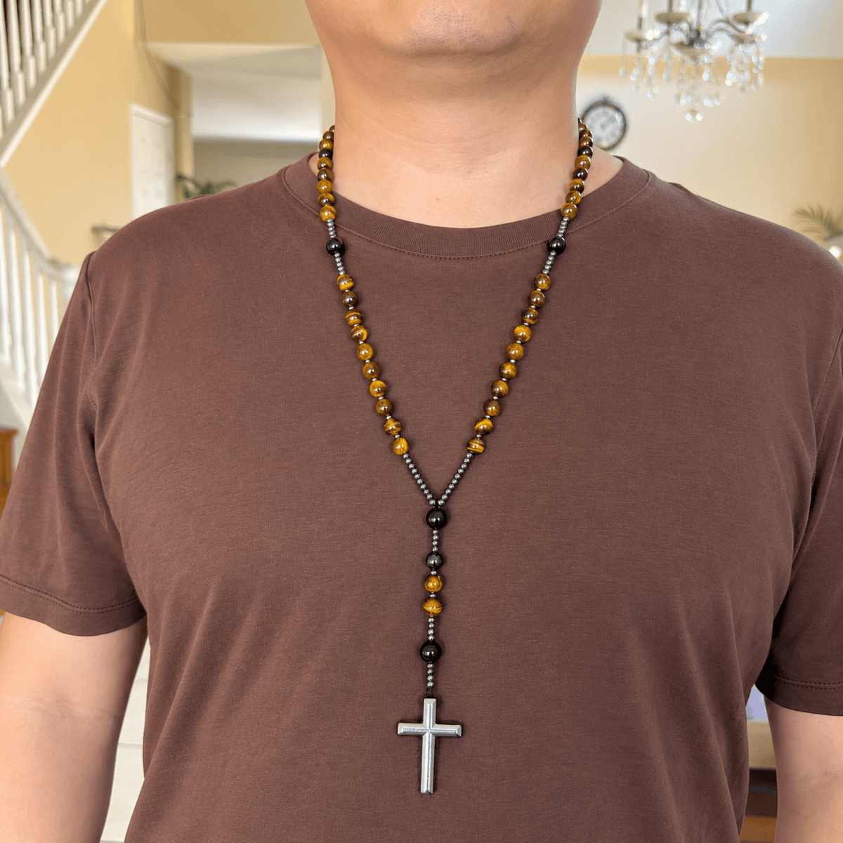 Natural Tiger's Eye rosary necklace with Hematite cross worn by a model