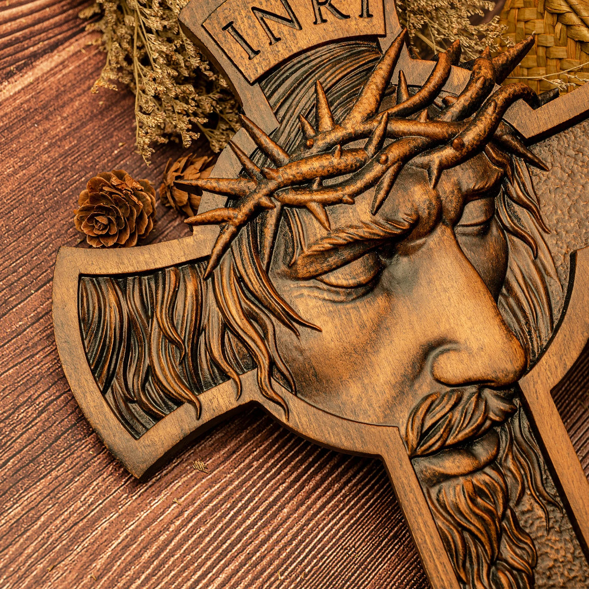 Close-up of a wooden Jesus crucifix showing detailed face carving and crown of thorns